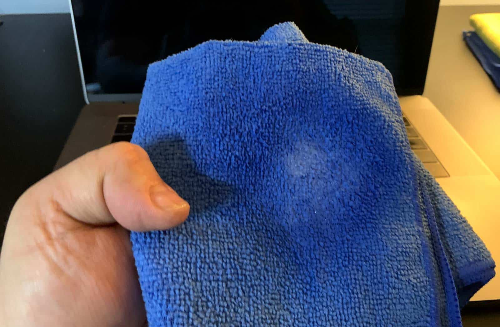 Use a damp microfiber cloth to wipe down your Macbook keyboard